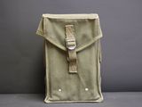 a close up of a bag with a belt on a table