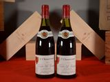 two bottles of wine sitting next to each other on a table