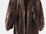 brown and black leopard print jacket hanging on a hanger