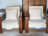 two chairs that are sitting next to each other in a room