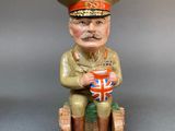 figurine of a soldier sitting on a bench with a british flag