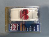 a toy car that is in a package on a table