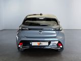 the rear end of a silver car in a white room