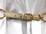 an image of a woman wearing a white dress and a gold belt