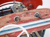 a red and blue toy airplane sitting on top of a table