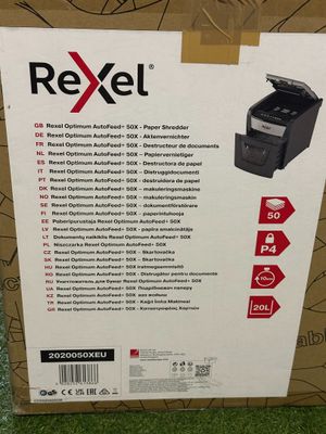a box of a printer sitting on top of a green carpet