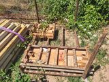 a pile of wooden pallets sitting in the grass