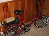 a red bike with a box on the back of it
