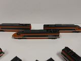 four trains that are sitting on the table together
