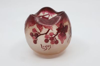 a small glass vase with a red flower on it