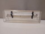 a clear box with a black handle on a white table