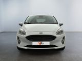 the front view of a white ford fiesta parked in a showroom