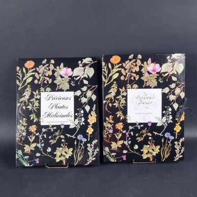 a pair of black books with floral designs on them