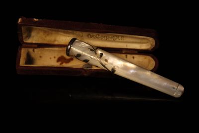 a silver pen sitting in a box on a table