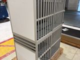a white refrigerator sitting on a pallet in a warehouse
