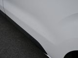 a white car parked in a parking lot with its door open