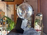 a glass ball sitting on top of a black table