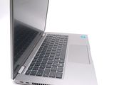a silver laptop computer sitting on top of a white table