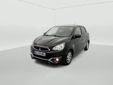 a black car is parked in a white room with a white wall
