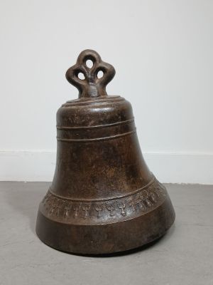 an old bronze bell with a cross on top of it