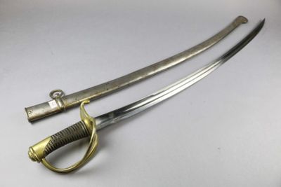 a close up of a pair of swords on a white surface