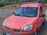 a red van that is parked in a parking lot