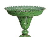 a green vase that is on a stand on a white background
