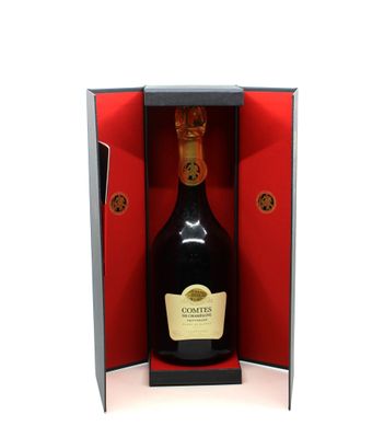 the bottle of champagne is in the open box on the table