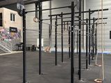 a gym area with a crossfit station in the middle of it