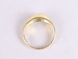 an image of a gold ring on a white surface