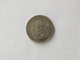 a coin that is sitting on a white surface