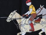 a picture of a man riding a horse on a black shirt