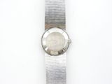 a close up of a watch on a white surface