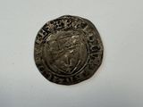 a close up of a coin on a table with a white background