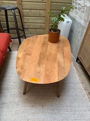 a wooden table with a potted plant on top of it