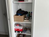 a closet with a lot of boxes and boxes on the shelves