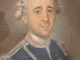 portrait of a man in a blue uniform with a medal around his neck