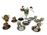 many cups and saucers that are sitting on the table