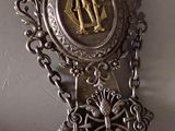 a silver and gold clock hanging on a wall