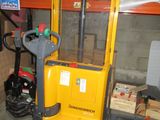 a yellow fork lift truck parked in a garage