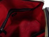 an image of a black and red bag with zippers
