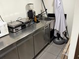 a kitchen with a sink, microwave, and other appliances in it