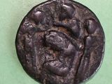 an old coin on a green surface with a picture of a man on it