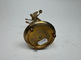 a gold clock that is sitting on a table