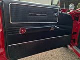 a red car with a black door and a black door handle