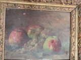 a painting of apples and grapes in a gold frame