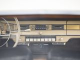 dashboard of an old car with steering controls and dashboard lights