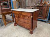 a marble top dresser in the middle of a room