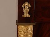 a clock that is on top of a wooden cabinet
