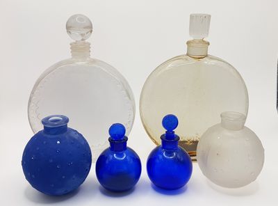 four different colored glass bottles sitting next to each other